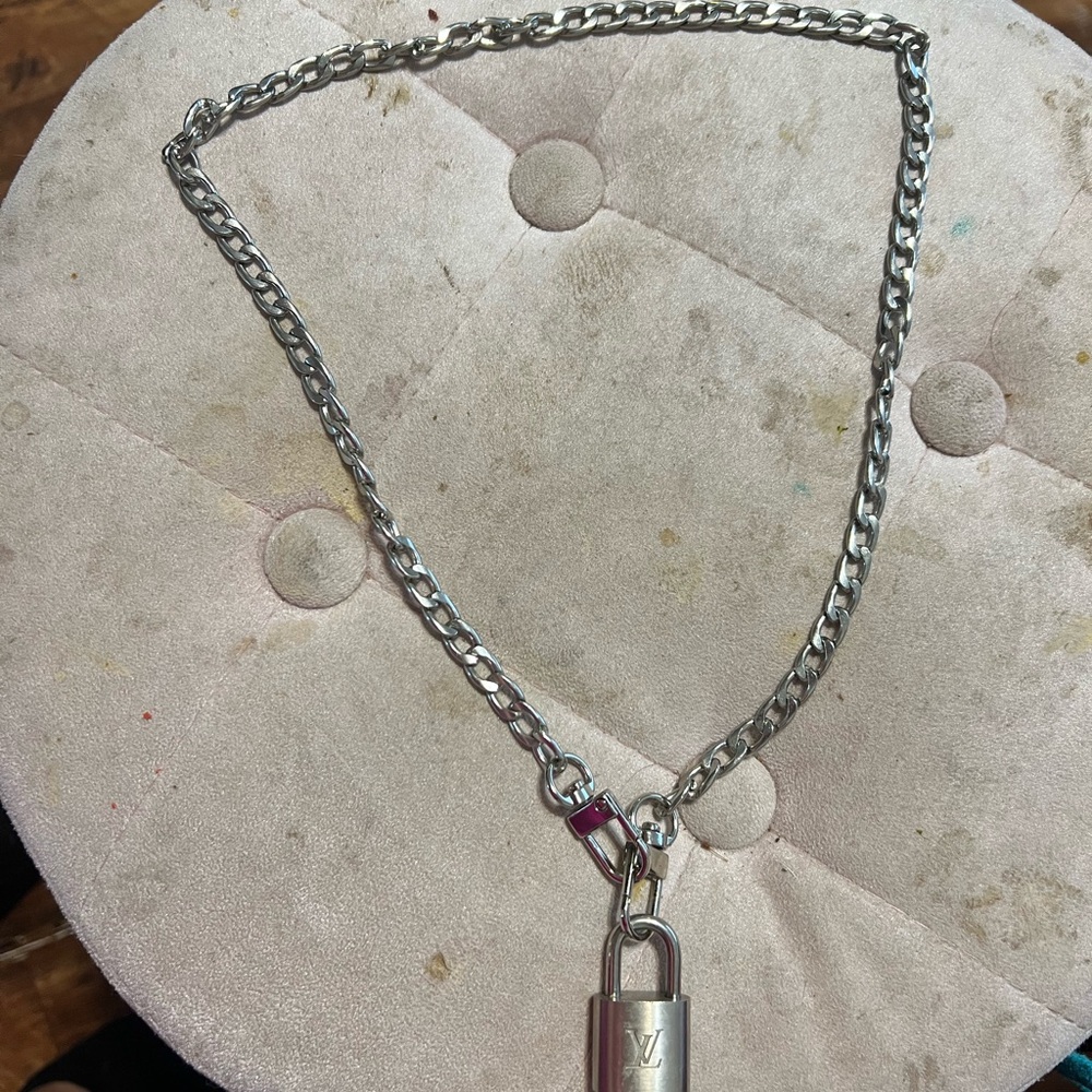 Silver Louis Vuitton chain lock and key